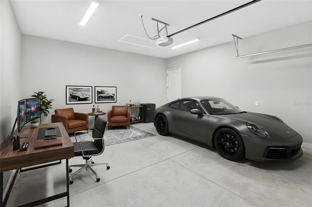 A garage converted into a home office featuring a desk, seating area, and parked car — 11943 SW 31ST ROAD, GAINESVILLE, FL