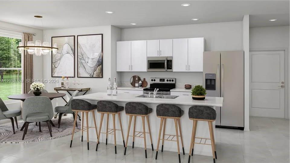 This is a rendering of a modern kitchen featuring a white island and stainless appliances — 12480 SW 248th ST # 2, Miami FL 33032, MIAMI, FL