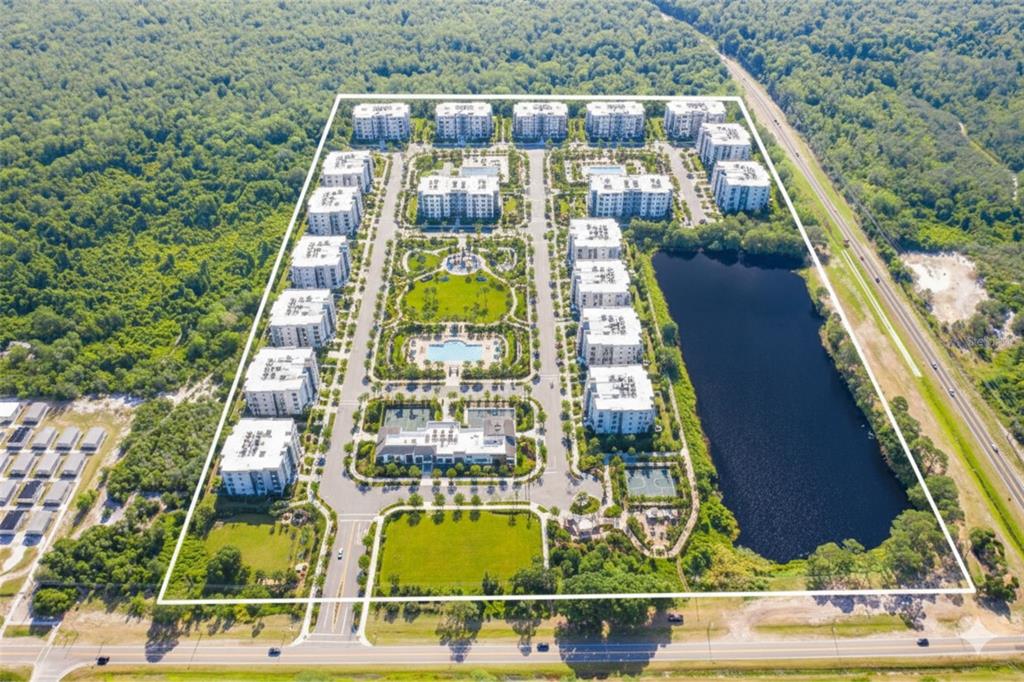 An aerial view shows an apartment complex with a central pool, park, and adjacent lake — LAUREL AVENUE, KISSIMMEE, FL