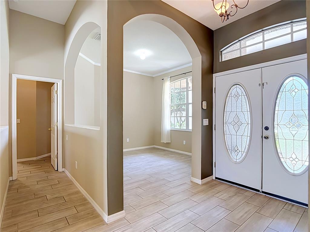 An entryway with tile flooring, an arched opening, and double front doors with glass inserts — 2866 DUNCAN TREE CIRCLE, VALRICO, FL