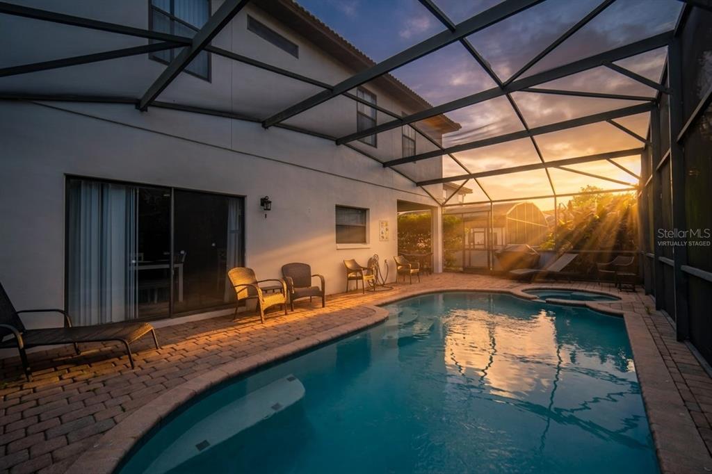 A two-story house with a white stucco exterior, a tile roof, and a concrete driveway — 16609 CARIBBEAN BREEZE WAY, CLERMONT, FL