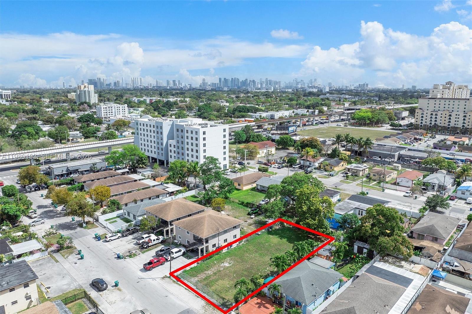 An aerial view shows a vacant rectangular lot outlined in red within a residential neighborhood — 2780 NW 56th St, Miami FL 33142, MIAMI, FL