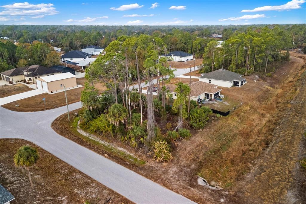 An aerial view shows a suburban residential lot with trees and nearby houses — DUMA WAY, NORTH PORT, FL