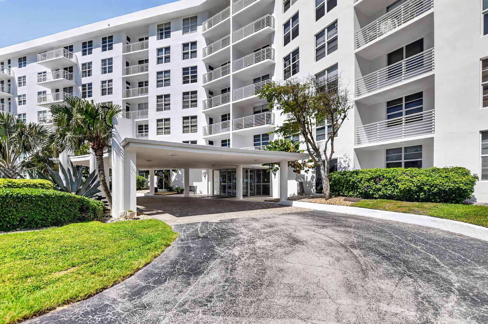 A multi-story white apartment building features a covered entrance and a paved driveway — 2851 S Ocean Boulevard # 2, Boca Raton FL 33432, BOCA RATON, FL