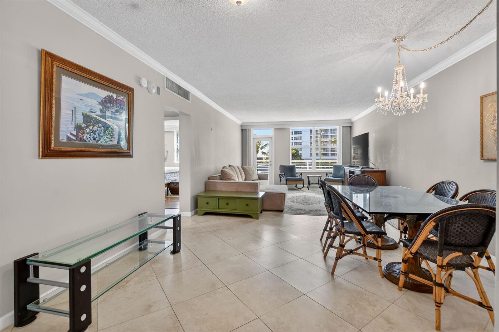 A living and dining area with tile floors, a glass dining table, and a chandelier — 2851 S Ocean Boulevard # 2, Boca Raton FL 33432, BOCA RATON, FL