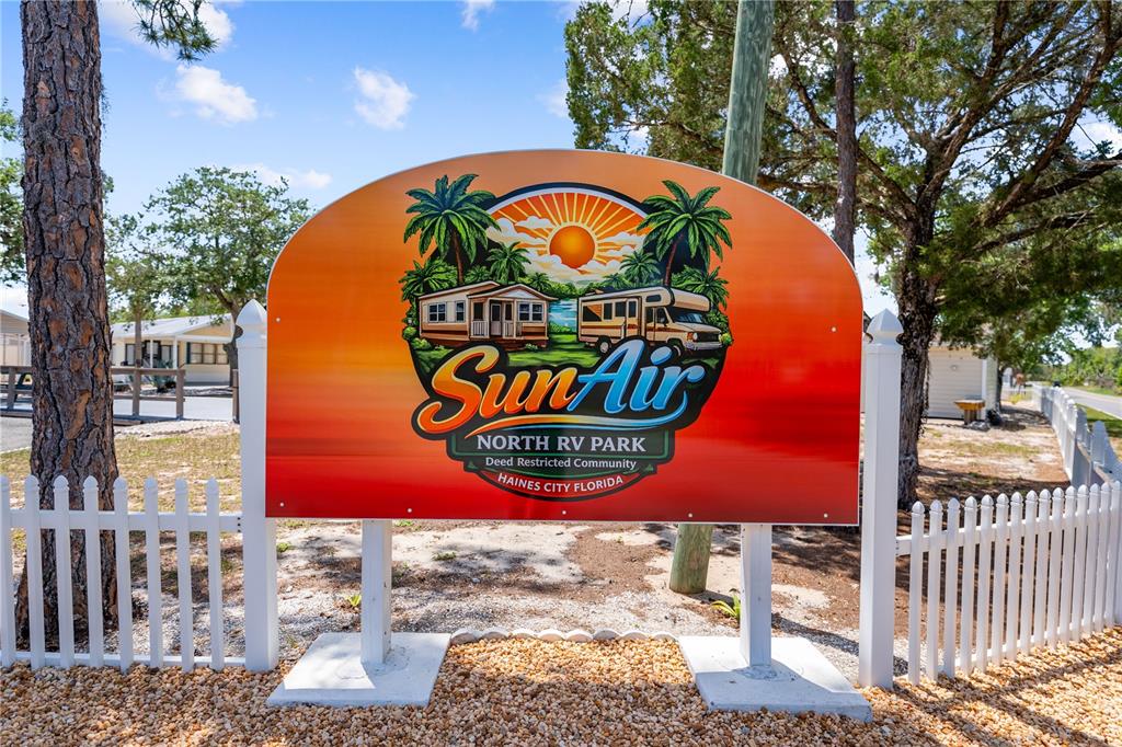 A sign for SunAir North RV Park stands behind a white picket fence — 34 FAIRVIEW DRIVE N, HAINES CITY, FL