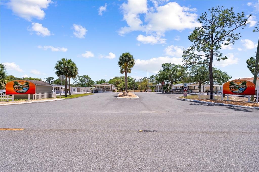 The entrance to a mobile home park features two Sun Air signs and palm trees — 34 FAIRVIEW DRIVE N, HAINES CITY, FL