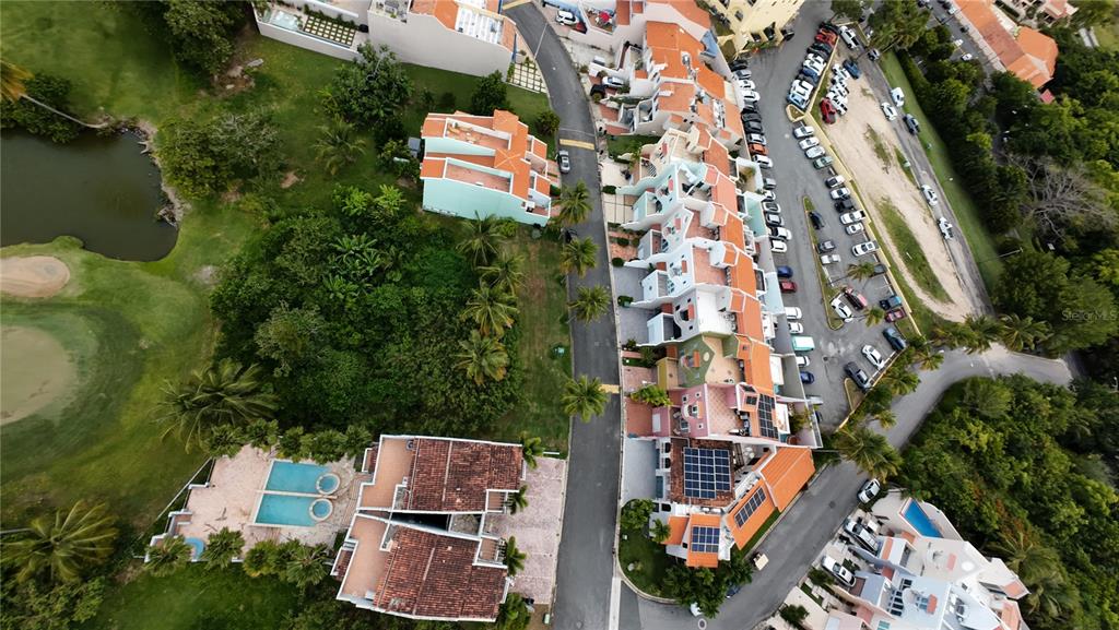 An aerial view shows a row of townhouses, a swimming pool, and a parking lot — MonteSol 11 PALMANOVA UNIT 150 - 151, HUMACAO, PR
