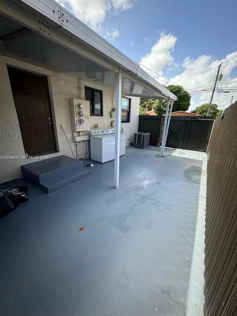 An outdoor patio area features a concrete floor, a covered porch, and a laundry appliance — 7360 SW 21st St # 7360, Miami FL 33155, MIAMI, FL