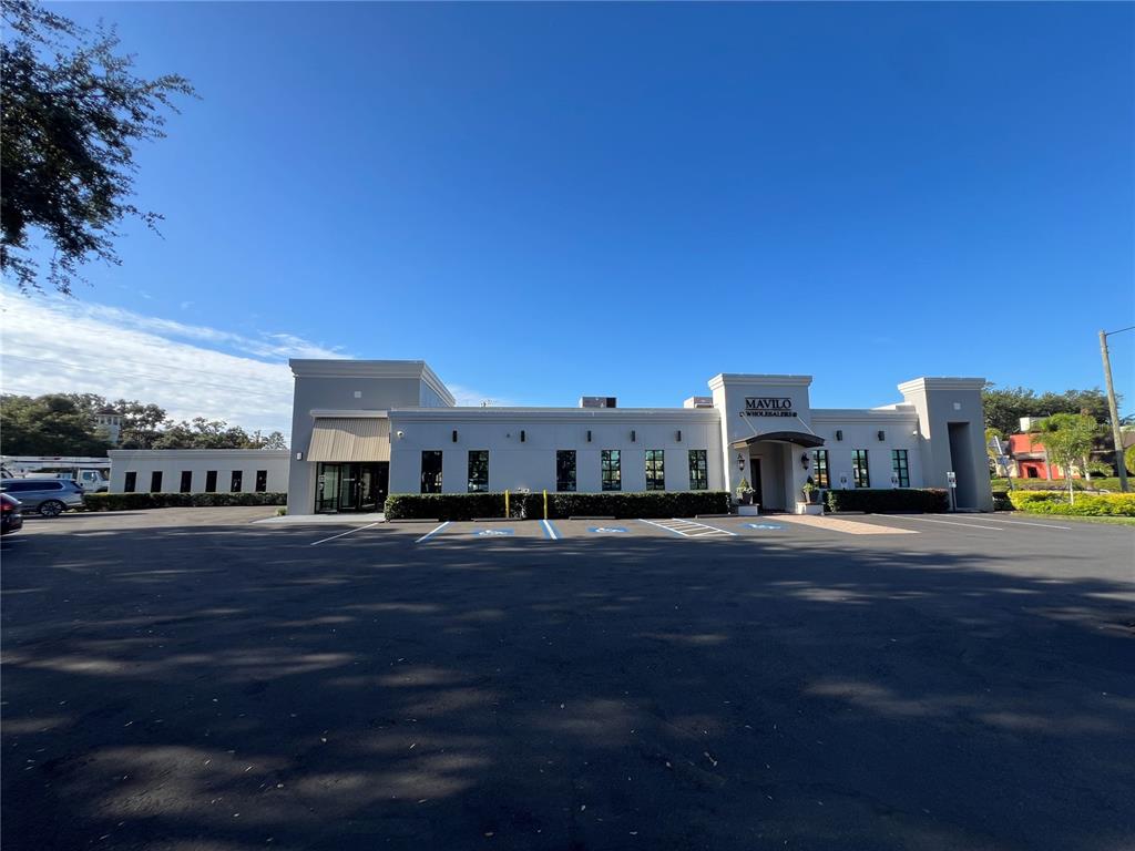 A single-story commercial building with a parking lot in front under a blue sky — 3410 HENDERSON BOULEVARD, TAMPA, FL