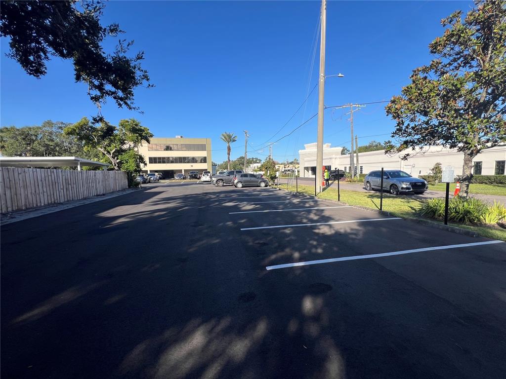 A paved parking lot with white painted spaces sits in front of commercial office buildings — 3410 HENDERSON BOULEVARD, TAMPA, FL