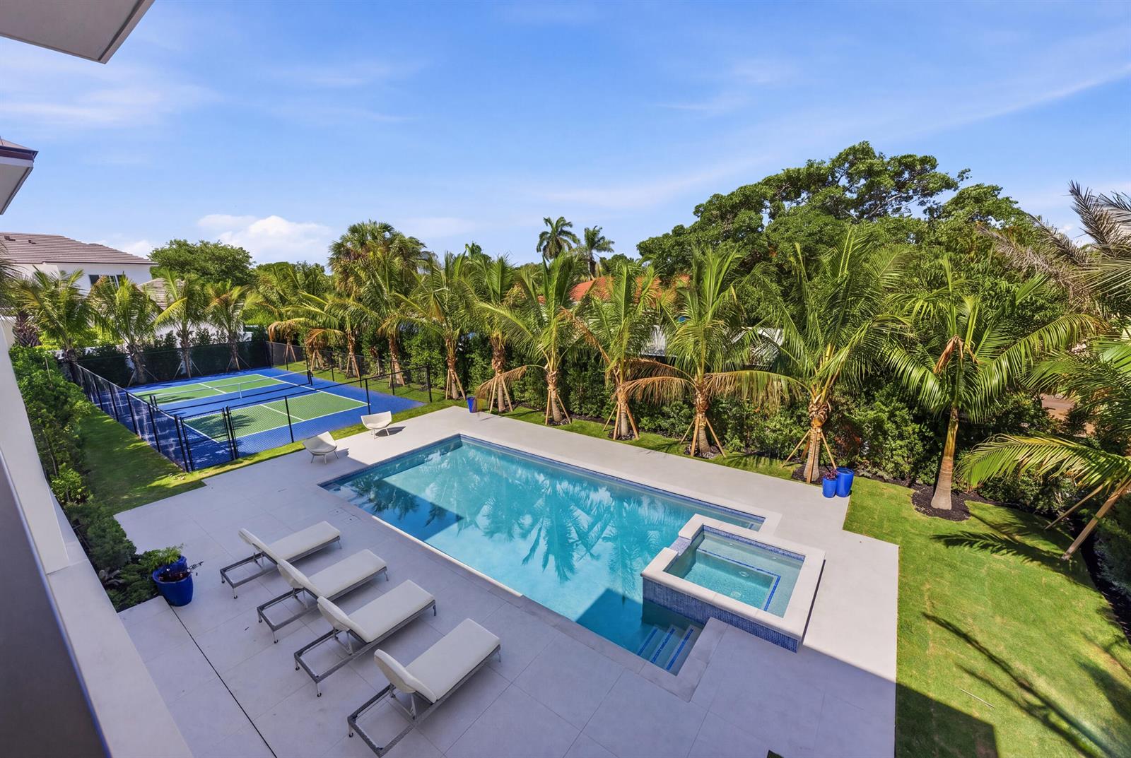 An aerial view of a backyard featuring a swimming pool, hot tub, and pickleball court — 210 Cortez Road, West Palm Beach FL 33405, WEST PALM BEACH, FL