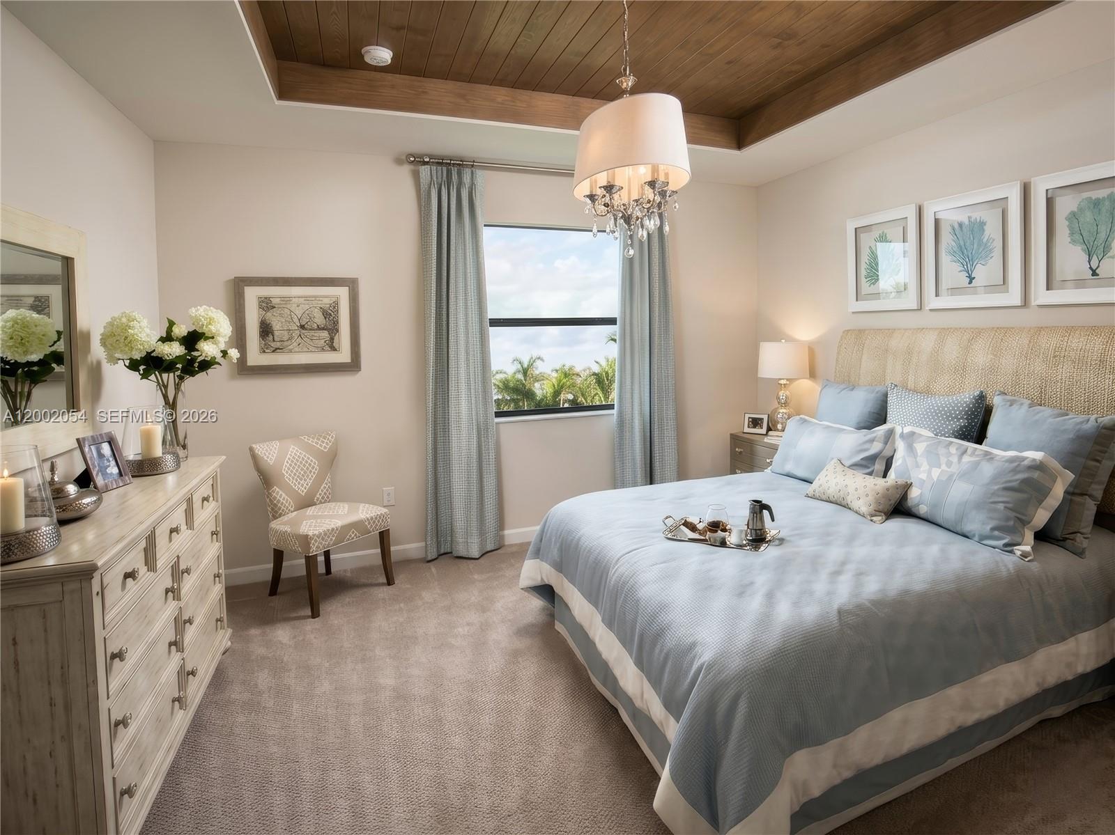 A bedroom features a tray ceiling, blue bedding, a dresser, and a window with palm trees — 12525 NW 23rd Pl, Miami FL 33167, MIAMI, FL