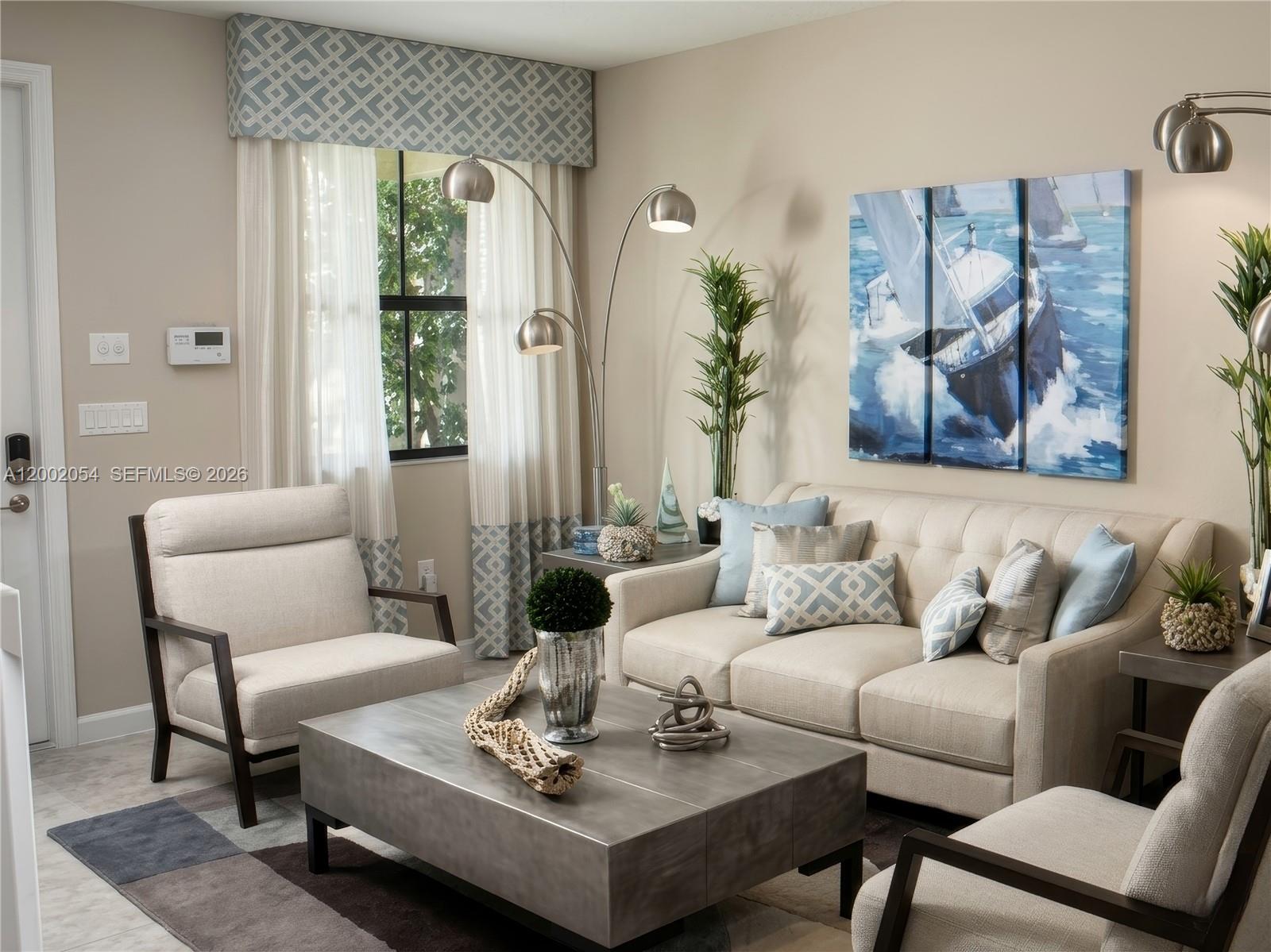 A living room features a beige sofa, two armchairs, a metal coffee table, and nautical artwork — 12525 NW 23rd Pl, Miami FL 33167, MIAMI, FL