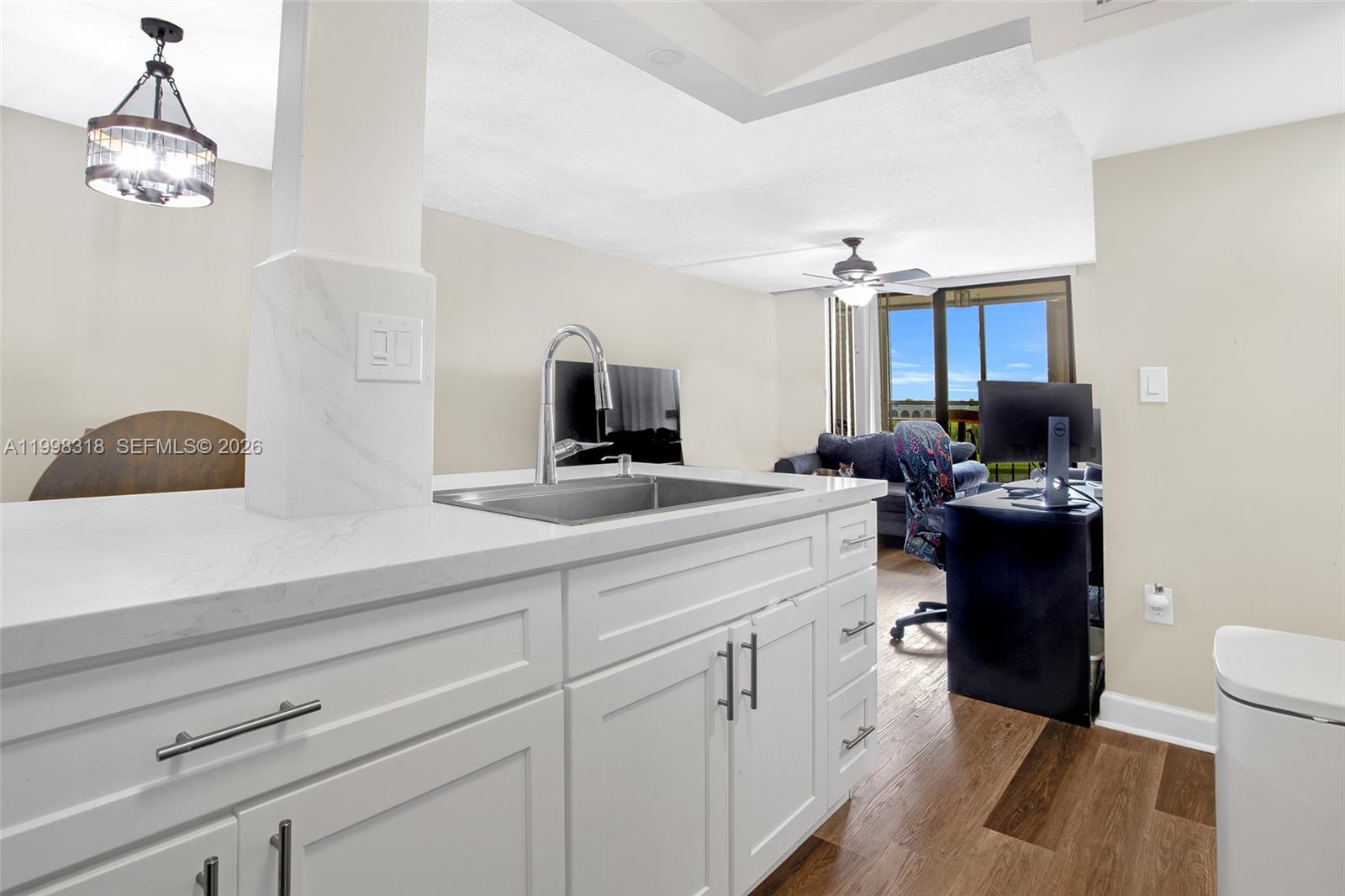 A kitchen features white cabinets, stainless steel appliances, and a white marble-look countertop — 9682 Fontainebleau Blvd # 503, Miami FL 33172, MIAMI, FL