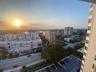 An elevated view of a city skyline at sunset with buildings, trees, and a parking lot — 1340 S Ocean Boulevard # 1509, Pompano Beach FL 33062, POMPANO BEACH, FL