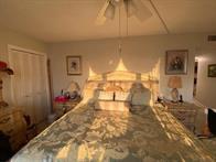 A bedroom features a large bed with a patterned comforter and a ceiling fan — 1340 S Ocean Boulevard # 1509, Pompano Beach FL 33062, POMPANO BEACH, FL