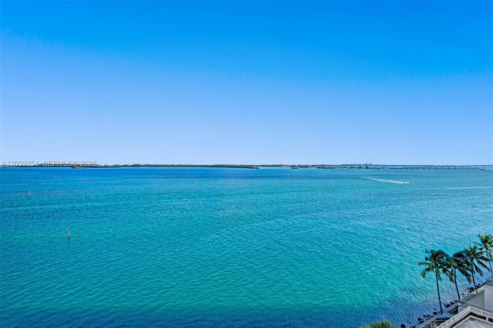 A high-angle view shows a calm turquoise bay under a clear blue sky — 770 Claughton Island Dr # 1014, Miami FL 33131, MIAMI, FL