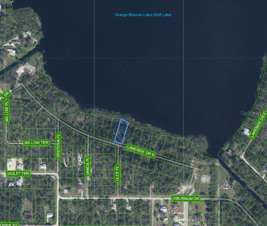 This is an aerial map showing a vacant lot highlighted in blue along a lake — 1302 LAKESIDE DRIVE S, SEBRING, FL