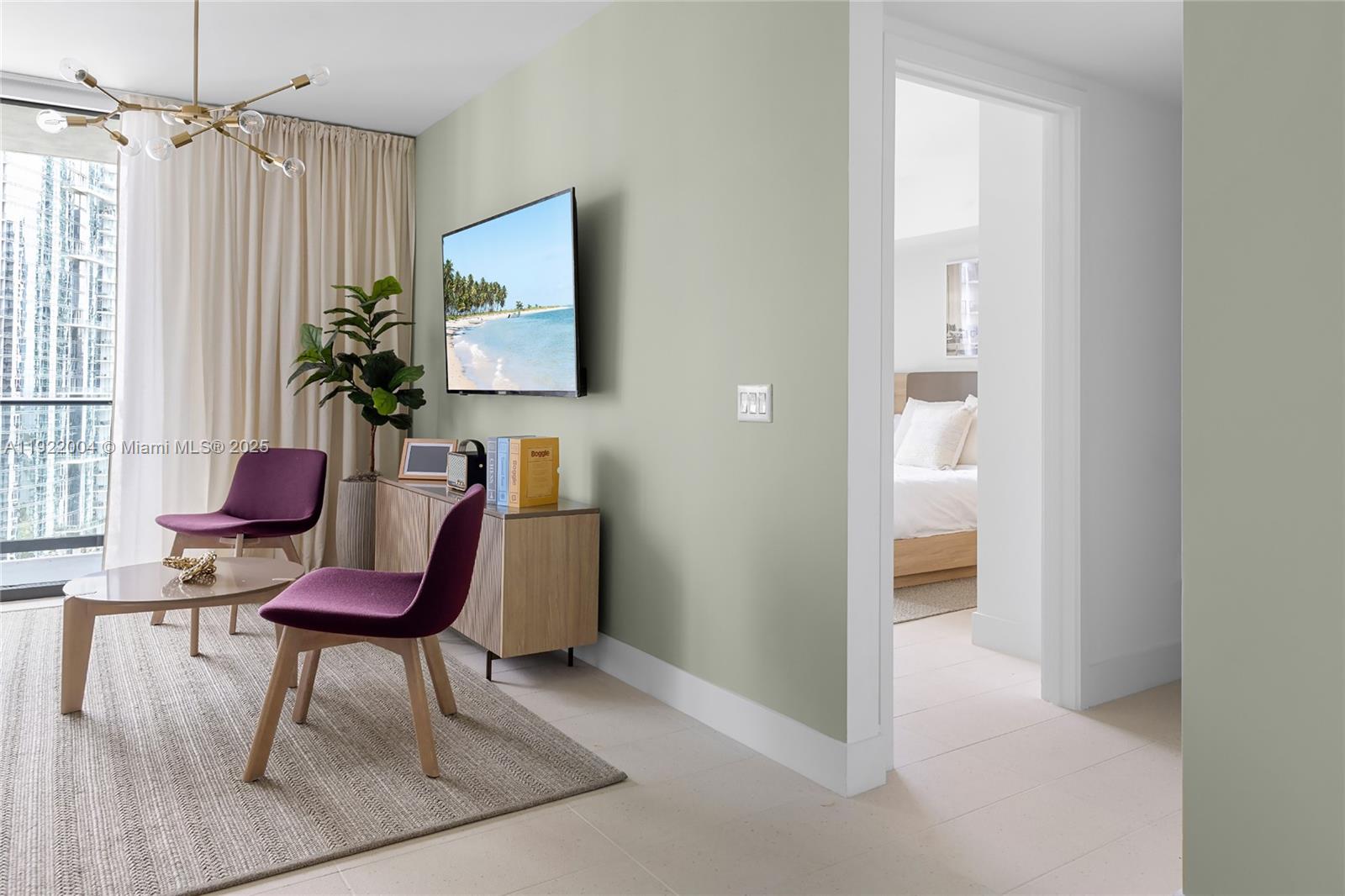 A living room with sage green walls, purple chairs, and a view of a bedroom — 159 NE 6th St # 3002, Miami FL 33132, MIAMI, FL