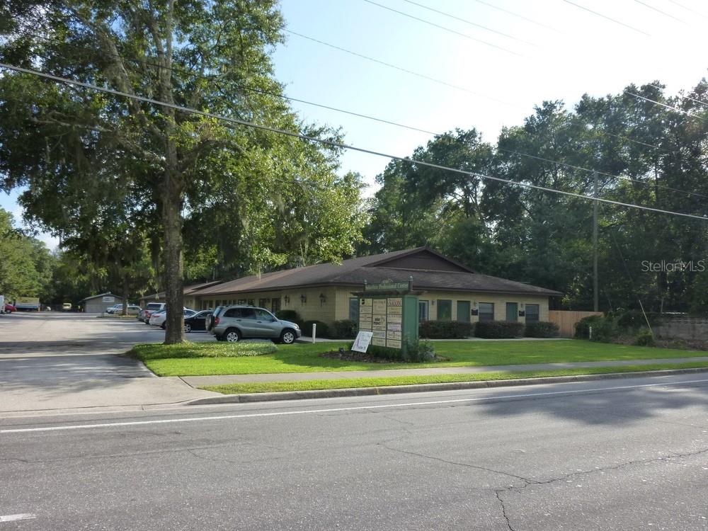 A single-story commercial building with a parking lot and a directory sign in front — 4509 NW 23RD AVENUE UNIT 19A, GAINESVILLE, FL