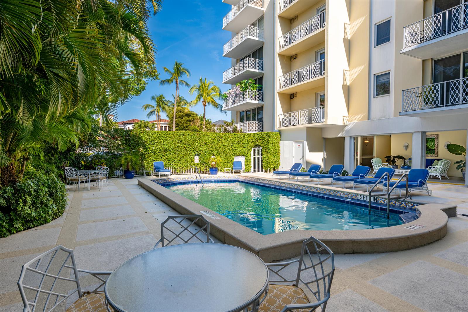 A dining and living area features green floral wallpaper, a round table, and large windows — 434 Chilean Avenue # 2b, Palm Beach FL 33480, PALM BEACH, FL