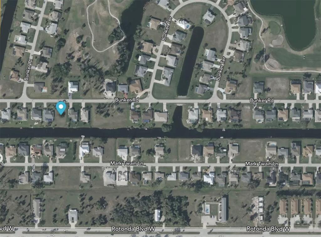 This is an aerial map view of a residential neighborhood with houses along a canal — 67 BUNKER ROAD, ROTONDA WEST, FL