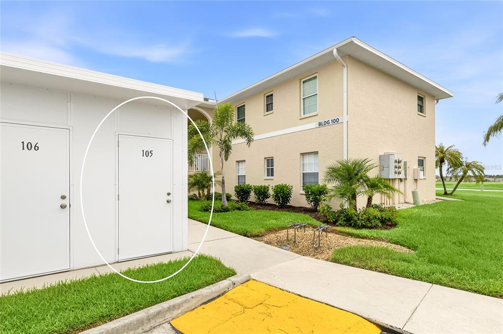 A white exterior storage door labeled 105 is circled next to a two-story apartment building — 5800 SABAL TRACE DRIVE UNIT 105, NORTH PORT, FL