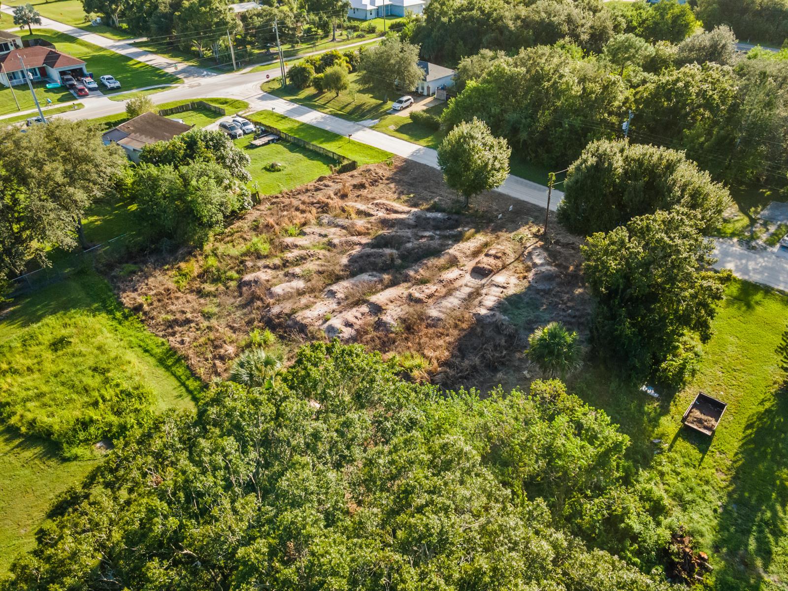 An aerial view of a vacant, partially cleared residential lot surrounded by trees and roads — 8720 92nd Avenue, Vero Beach FL 32967, VERO BEACH, FL