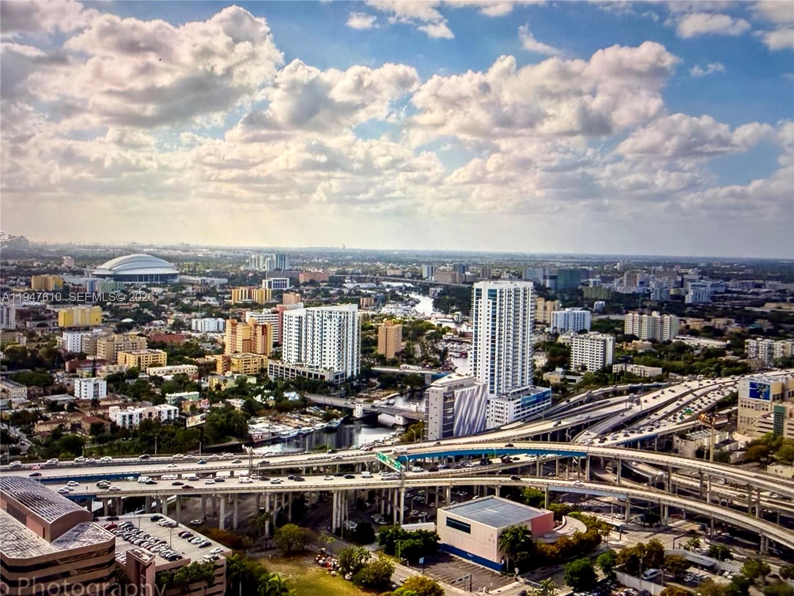 An aerial view of a city skyline featuring a large highway interchange and high-rise buildings — 92 SW 3rd St # 4709, Miami FL 33130, MIAMI, FL