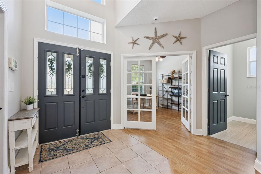 An entryway features a dark double front door, tile flooring, and French doors to an office — 2563 WALNUT HEIGHTS ROAD, APOPKA, FL