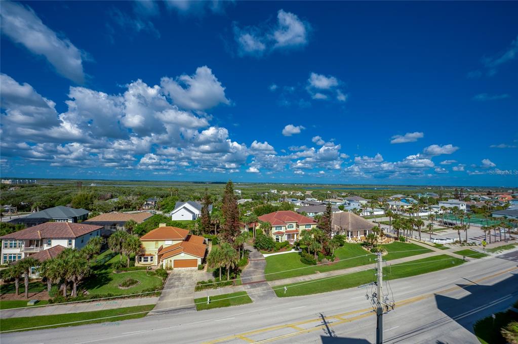 An aerial view shows several suburban houses with tiled roofs near a coastal waterway — 4535 S ATLANTIC AVENUE UNIT 2701, PORT ORANGE, FL