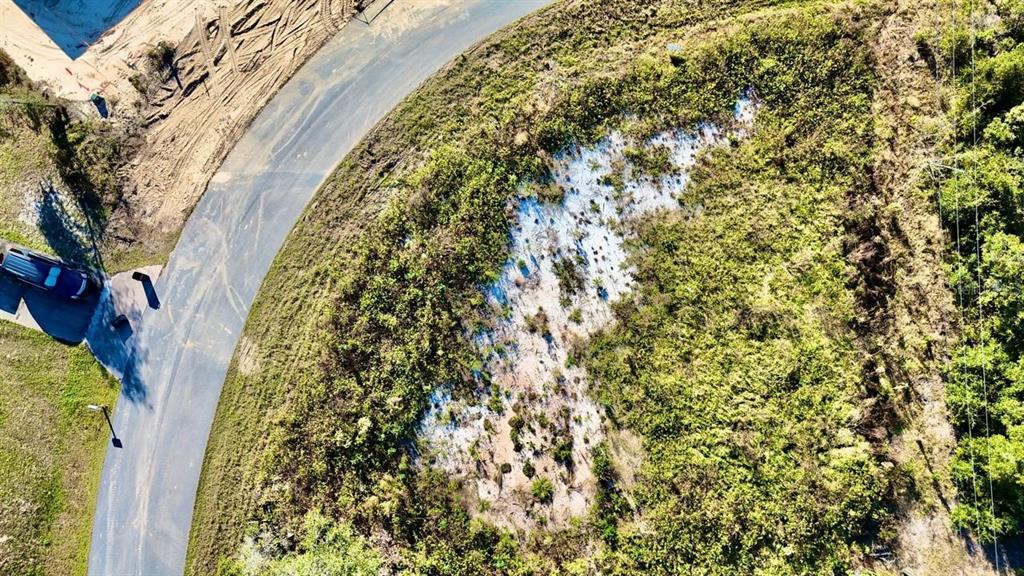 An aerial view shows a vacant, partially cleared lot next to a paved road — 15800 SW 37TH CIRCLE, OCALA, FL