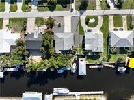 An aerial view shows several waterfront homes with private docks along a canal — 1740 NW 20TH AVENUE, CRYSTAL RIVER, FL