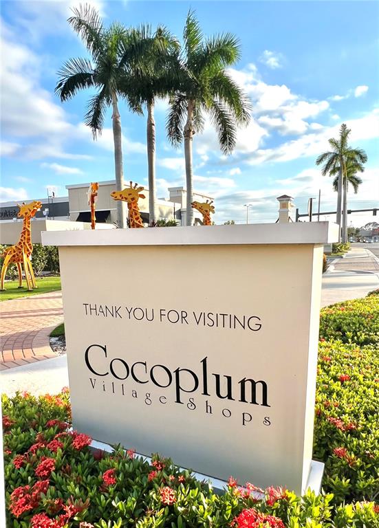 A sign for Cocoplum Village Shops stands in front of palm trees and giraffe sculptures — 12468 KOENIG LANE, PORT CHARLOTTE, FL