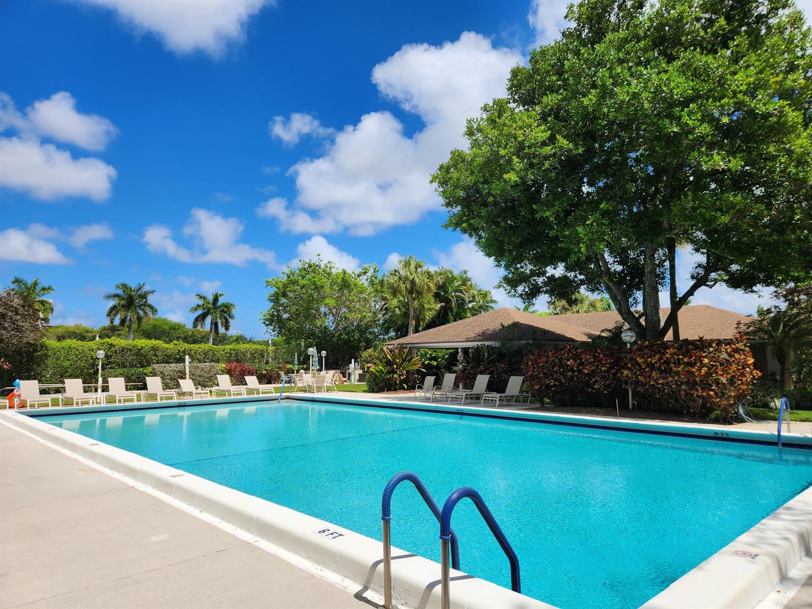 A multi-story apartment building with a covered entrance and parking lot in front — 4030 W Palm Aire Drive # 101, Pompano Beach FL 33069, POMPANO BEACH, FL