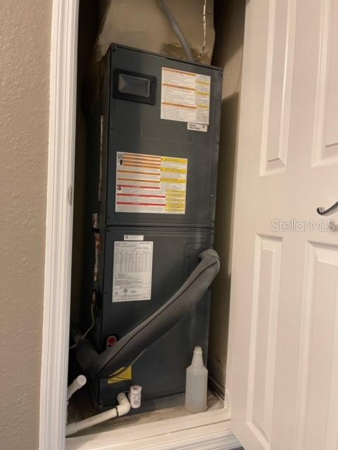 A vertical HVAC air handler unit is installed inside a small utility closet — 6434 CAVA ALTA DRIVE UNIT 406, ORLANDO, FL