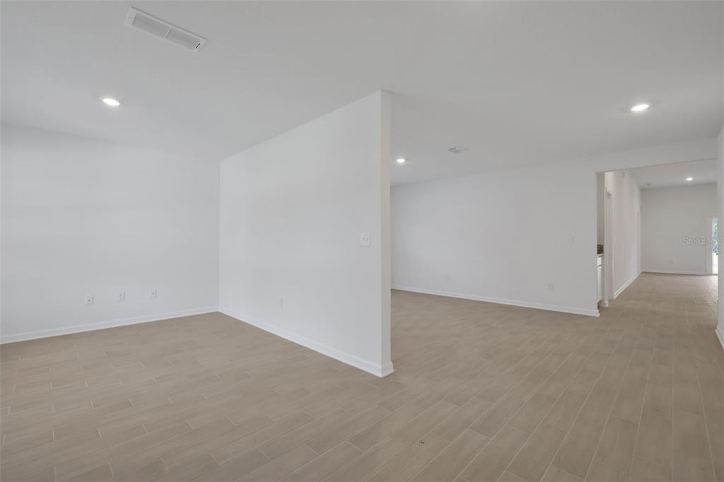 An interior view of a room with white walls, recessed lighting, and light-colored tile flooring — 3770 HOLSTEIN WAY, GREEN COVE SPRINGS, FL