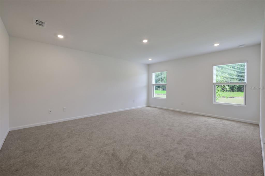 An empty bedroom with white walls, beige carpeting, recessed lighting, and two windows — 3770 HOLSTEIN WAY, GREEN COVE SPRINGS, FL