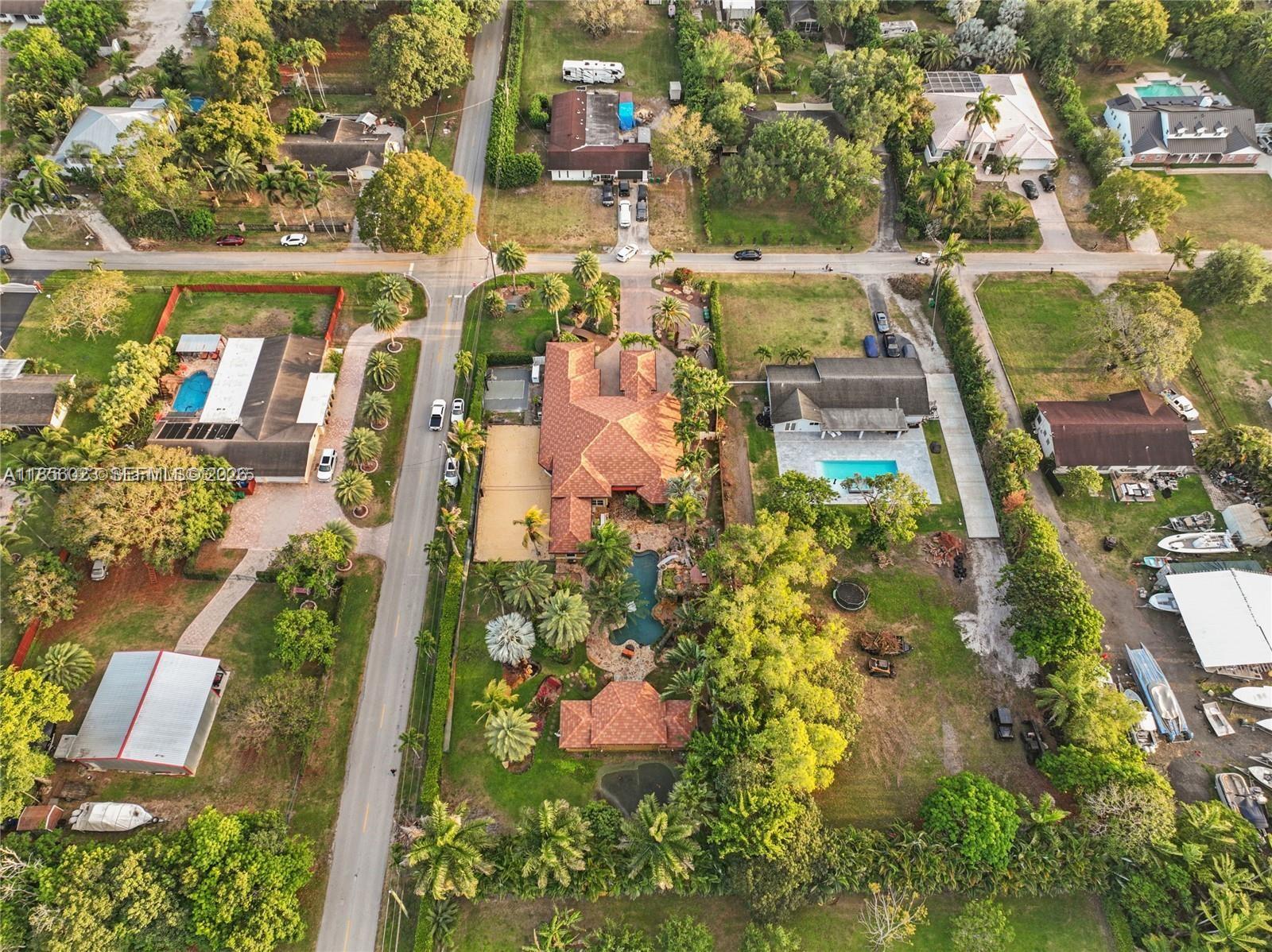 An aerial view shows a large residential property with a pool, landscaping, and surrounding houses — 14503 SW 16th St, Davie FL 33325, DAVIE, FL