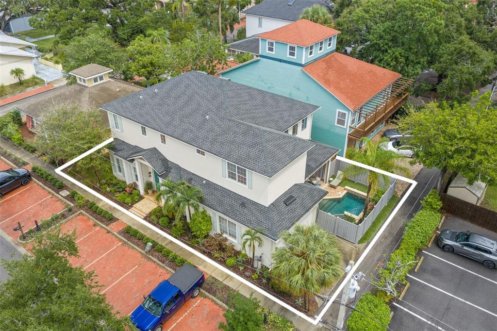 An aerial view shows a two-story house with a grey roof, pool, and surrounding landscaping — 429 2ND STREET S, SAFETY HARBOR, FL
