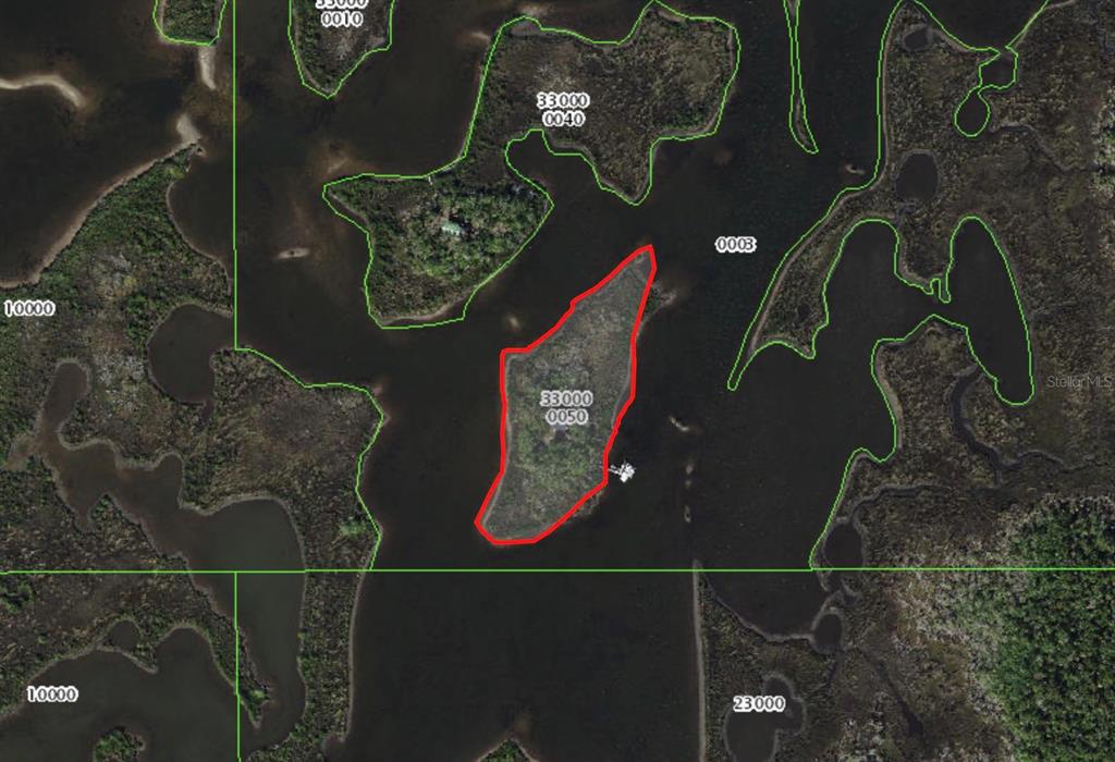 This is an aerial map showing a small, red-outlined island surrounded by water and marshland — 7472 W THUNDERBIRD ISLAND, HOMOSASSA, FL