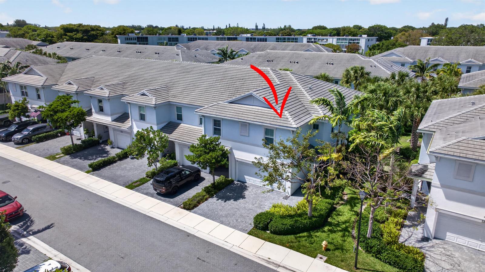An aerial view shows a two-story townhouse with a gray tiled roof and driveway — 1835 Sandpiper Pointe Place, Deerfield Beach FL 33442, DEERFIELD BEACH, FL
