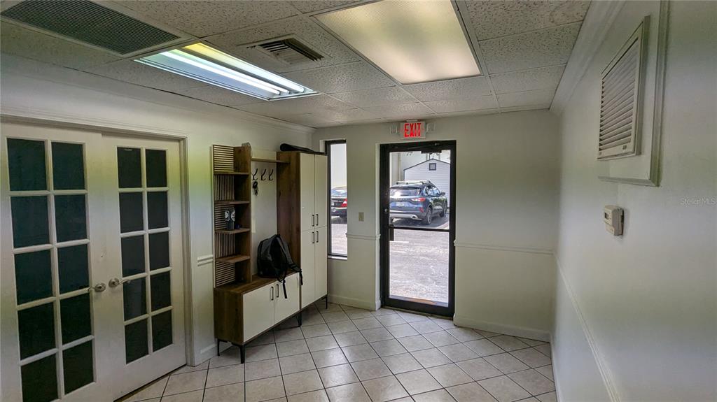 An entryway features tiled floors, a coat rack, French doors, and a glass-paneled exit door — 11920 31ST COURT N, ST PETERSBURG, FL
