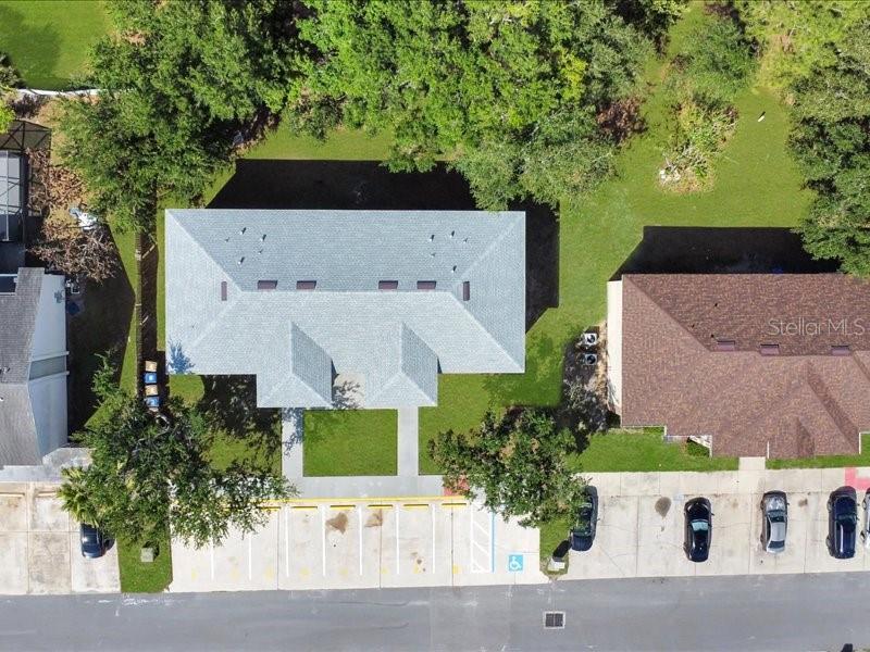An aerial view shows two adjacent buildings with gray and brown roofs and parking lots — 206 MAJORS LANE UNIT A, KISSIMMEE, FL