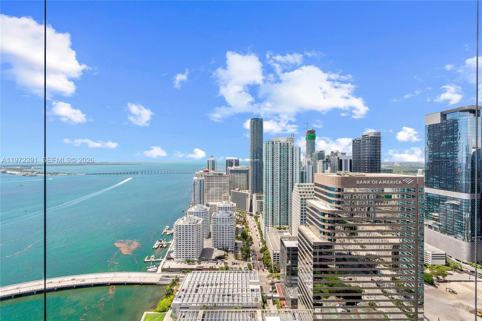 A high-angle view shows the Miami skyline, Biscayne Bay, and a bridge — 495 Brickell Ave # 4705, Miami FL 33131, MIAMI, FL