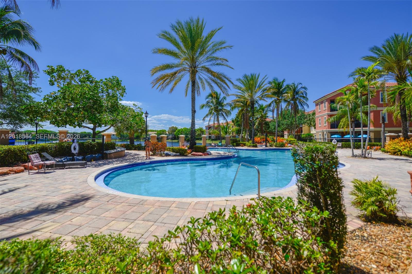 An outdoor swimming pool surrounded by palm trees and a multi-story apartment building — 4402 SW 160th Ave # 934, Miramar FL 33027, MIRAMAR, FL
