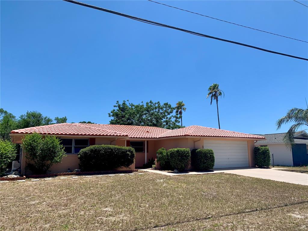 A single-story house with a terracotta tile roof and a two-car garage — 8024 JASMINE BOULEVARD, PORT RICHEY, FL