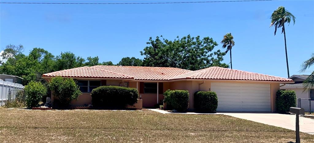 A single-story house with a terracotta tile roof and a two-car garage — 8024 JASMINE BOULEVARD, PORT RICHEY, FL