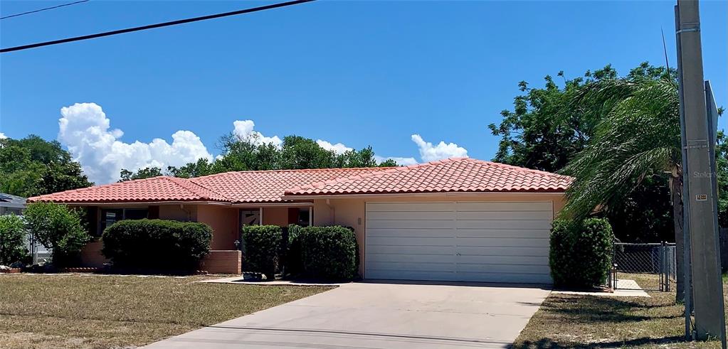 A single-story house with a terracotta tile roof and a two-car garage — 8024 JASMINE BOULEVARD, PORT RICHEY, FL